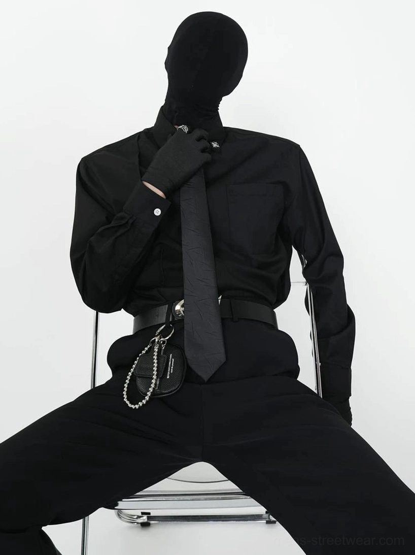 Black monochrome dress shirt and matching black tie set styled with gloves, silver crossbody chain bag, and waist chain in Korean streetwear look