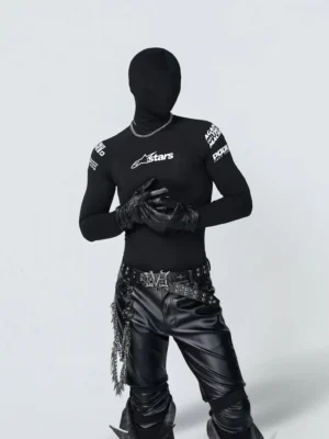 Black fitted motorsport long sleeve baselayer tee styled with leather pants, chain belt, gloves, and racing graphic prints