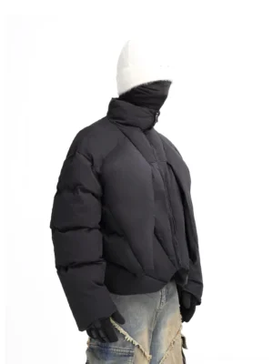 Black nebula sculpted cropped puffer jacket shown in left side three-quarter view with oversized padded sleeves and high stand collar