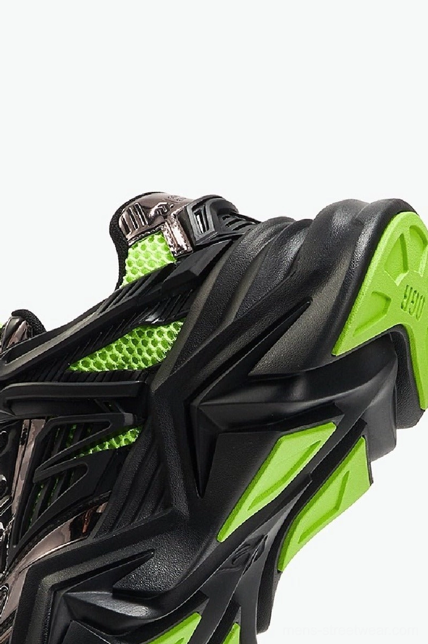 Close-up rear view of black silver neon green chunky cyberpunk sneakers showing breathable mesh overlays and rugged outsole