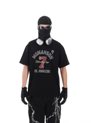 Black oversized number 7 graphic T-shirt styled with balaclava mirrored sunglasses leather gloves and wide-leg street punk trousers