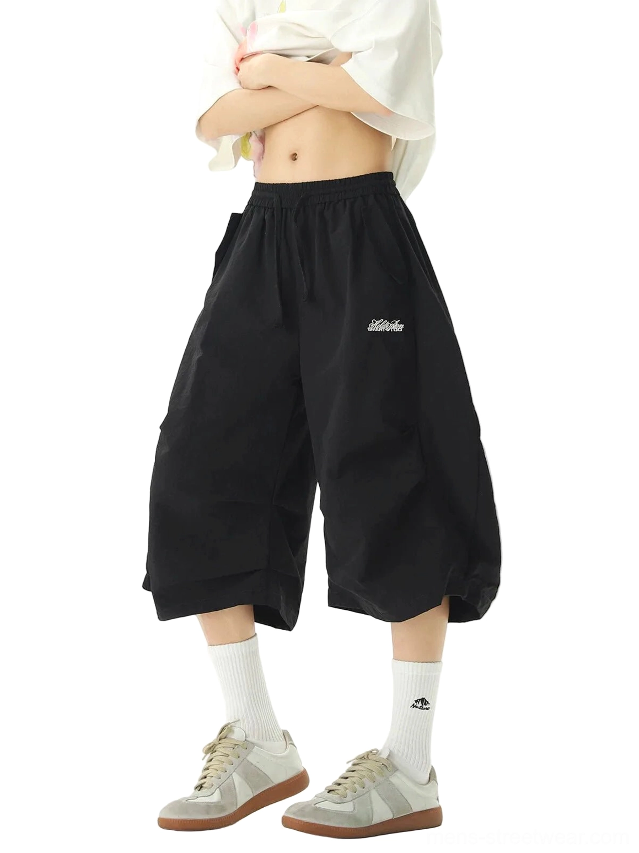 Front view of black nylon balloon jogger shorts styled as contemporary Seoul streetwear with oversized cropped silhouette