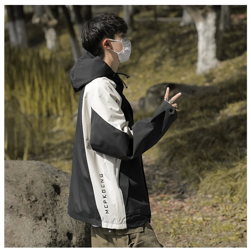 Side back view of a black and off-white colorblock outdoor windbreaker jacket with adjustable hood