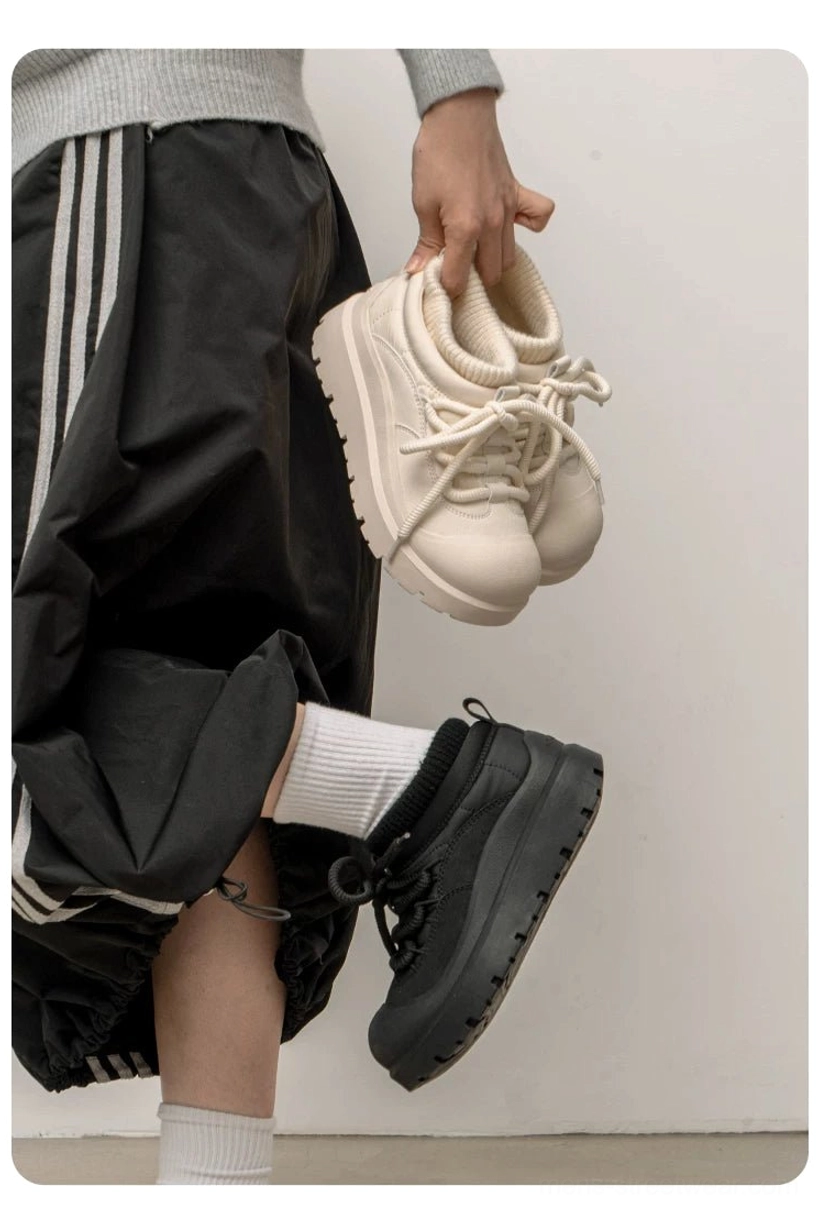 Black and off-white platform sneakers shown in a two-tone streetwear styling view with smooth matte upper and lace-up construction