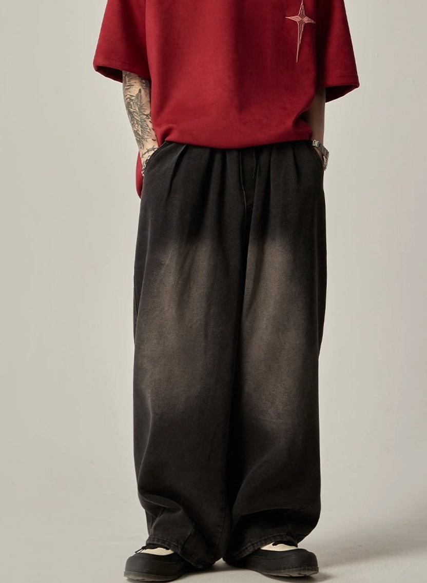Front view of black ombre fade wide-leg jeans with elasticated waistband and relaxed Korean streetwear fit