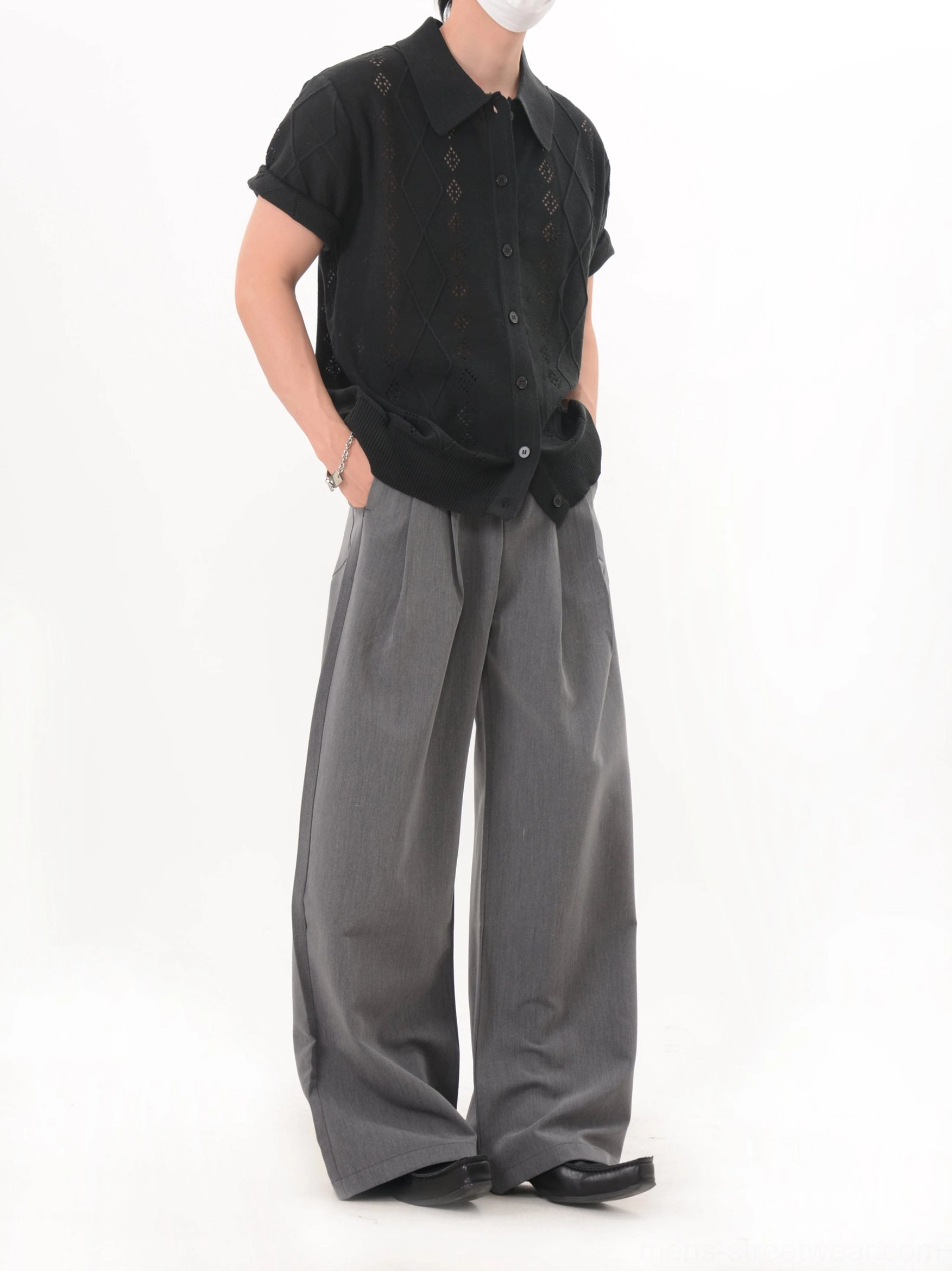 Black openwork argyle knit polo cardigan with front button placket shown in a relaxed side three-quarter outfit