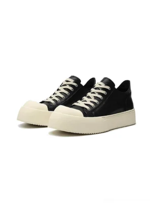 Black Oreo low-top platform streetwear sneakers front view with black upper and off-white rubber toe cap
