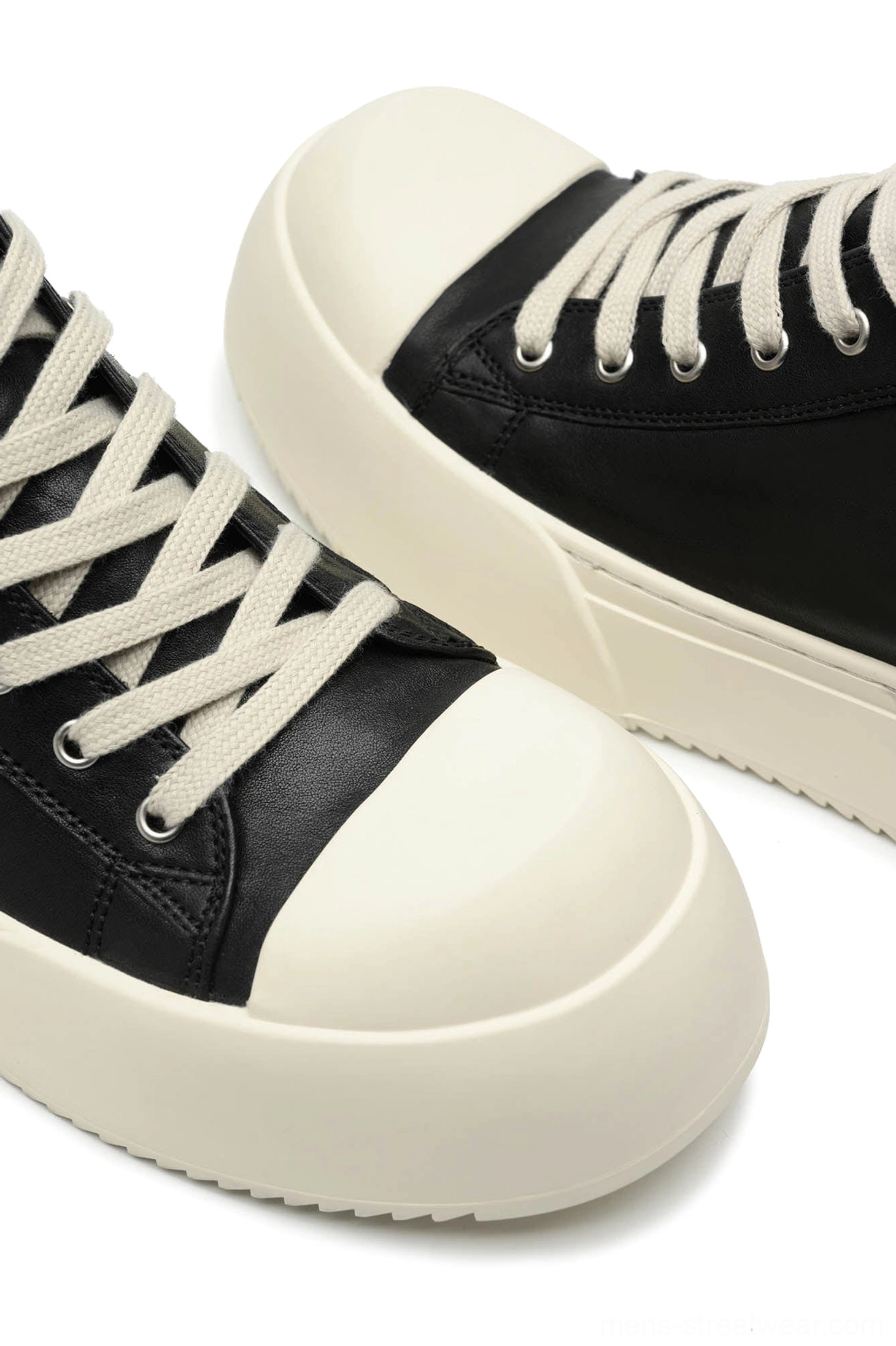 Black Oreo low-top platform streetwear sneakers close product view highlighting the lace-up low-top silhouette