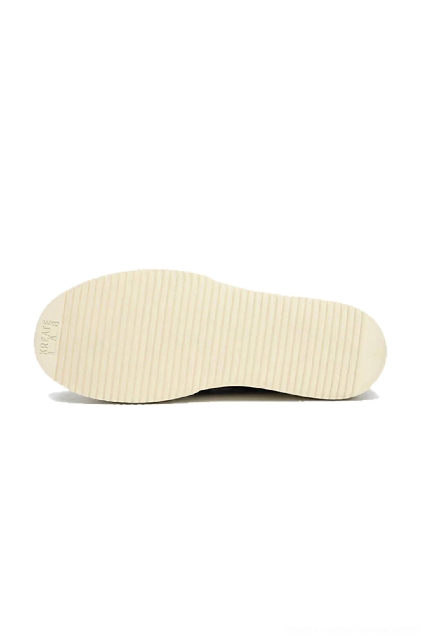 Textured off-white rubber outsole of Black Oreo low-top platform streetwear sneakers with striped traction pattern