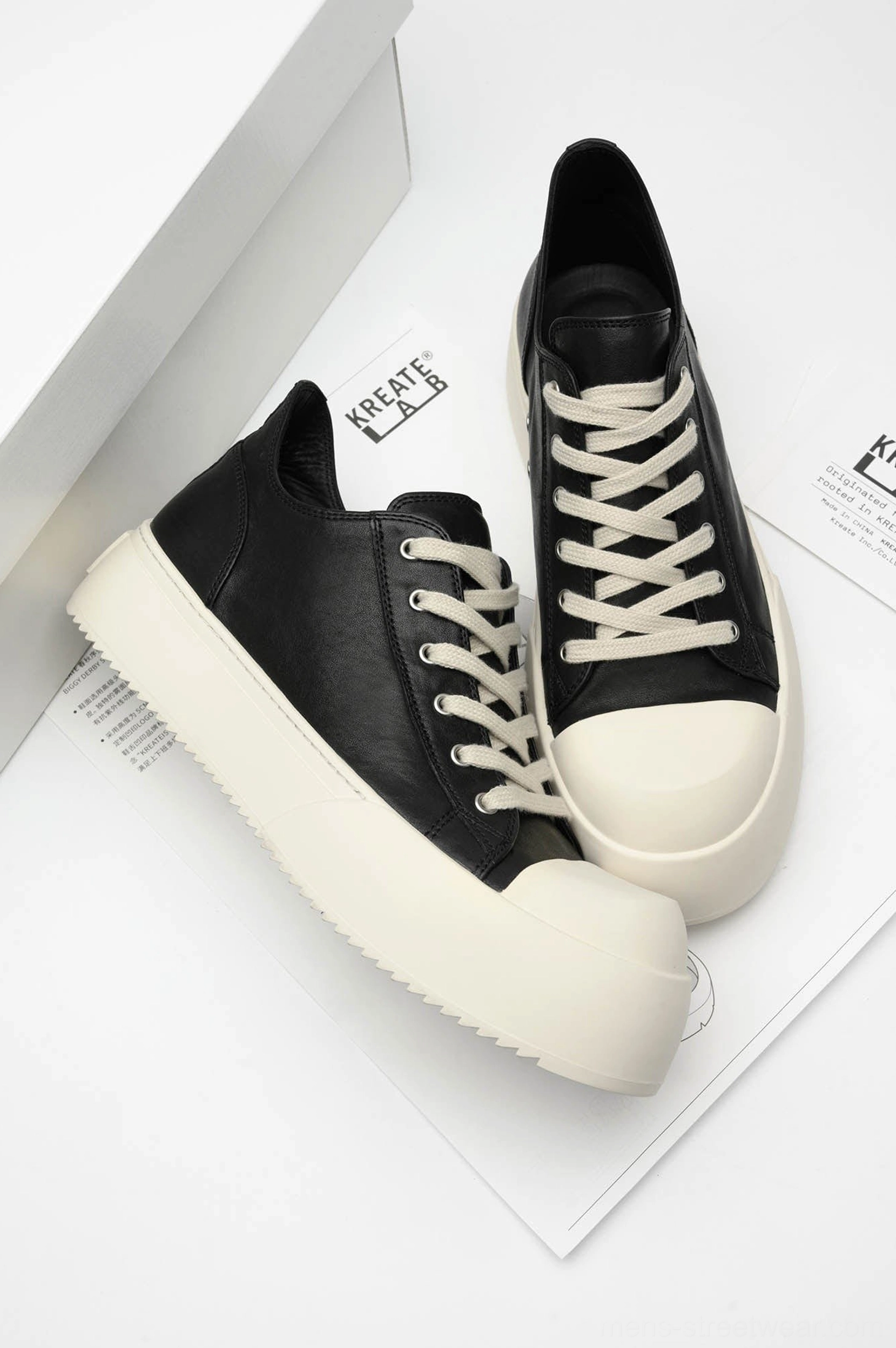 Top angled view of Black Oreo low-top platform streetwear sneakers showing black lace-up uppers and cream soles