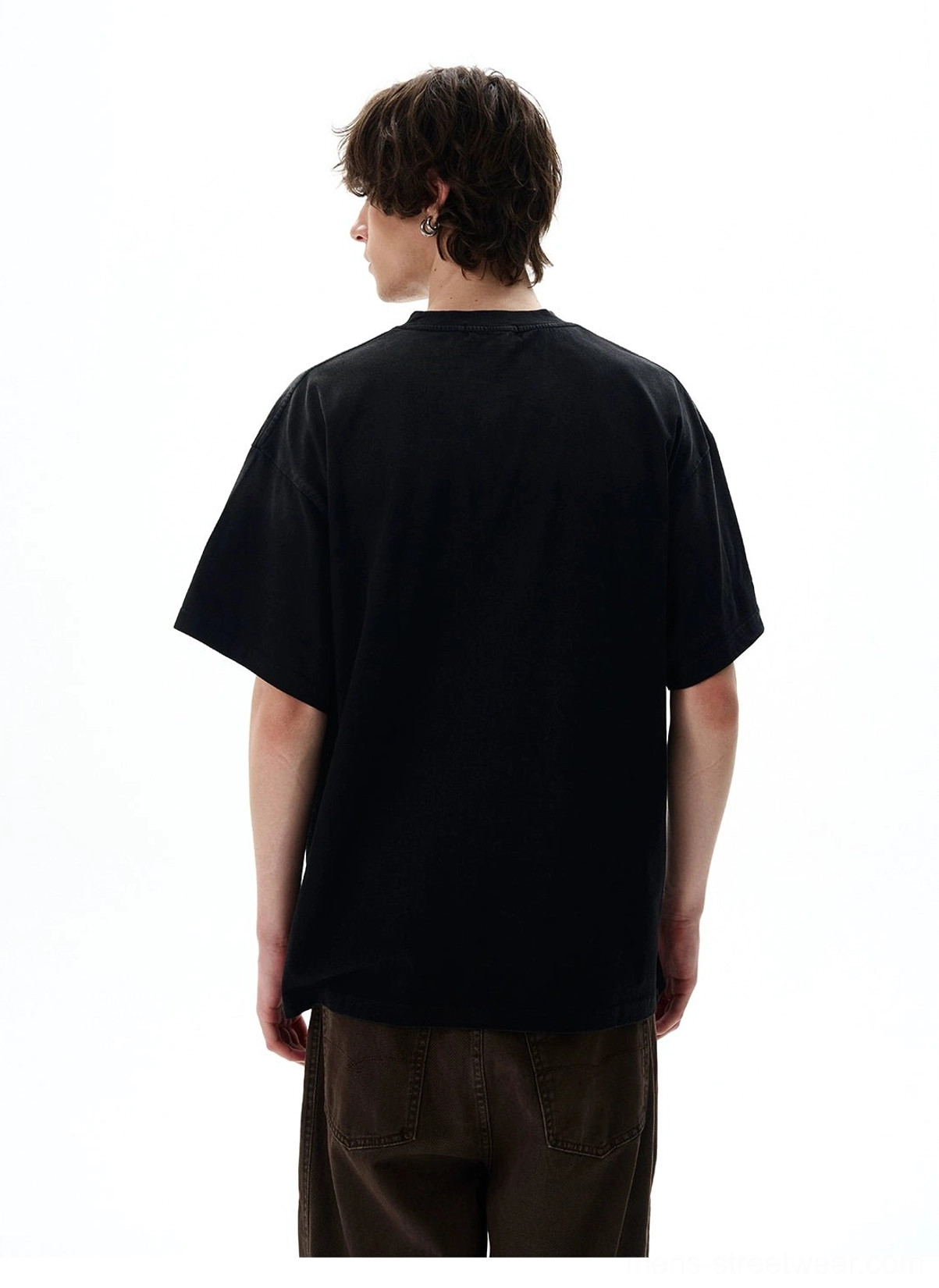 Back view of black oversized basic crewneck T-shirt with a clean solid finish styled with brown wide-leg pants