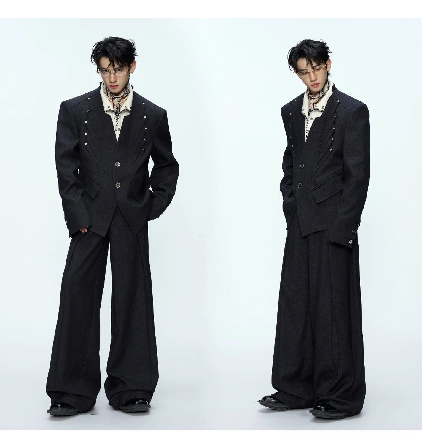 Side views of black oversized blazer and draped wide-leg trousers with printed neck scarf styling