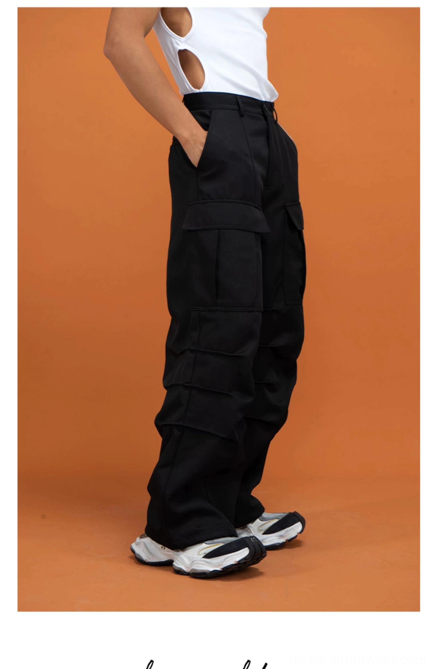 Black oversized cargo pants shown in side profile with thigh flap pockets, wide silhouette, and visible rear waist pocket