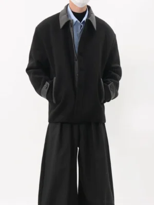 Black oversized contrast collar streetwear jacket shown from the front with textured fabric, pointed collar, long sleeves, side pockets, and relaxed Seoul fashion styling