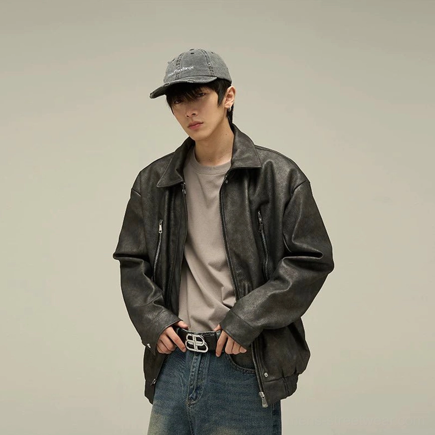 Black oversized faux leather jacket with optional cotton-padded construction, contemporary Korean streetwear fit, zip pockets, and layered winter styling