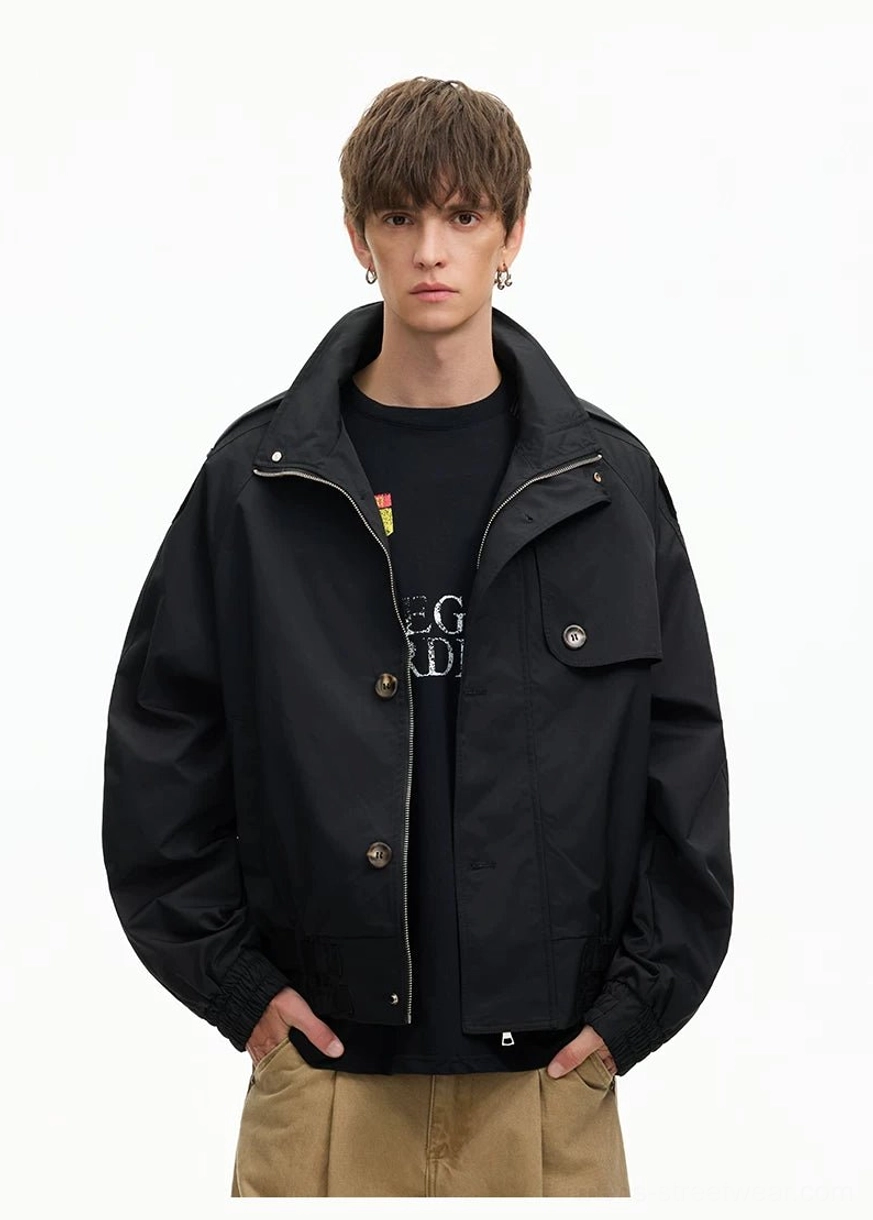 Black oversized cropped windbreaker jacket with partial zip button closure chest flap pocket and relaxed Korean streetwear fit