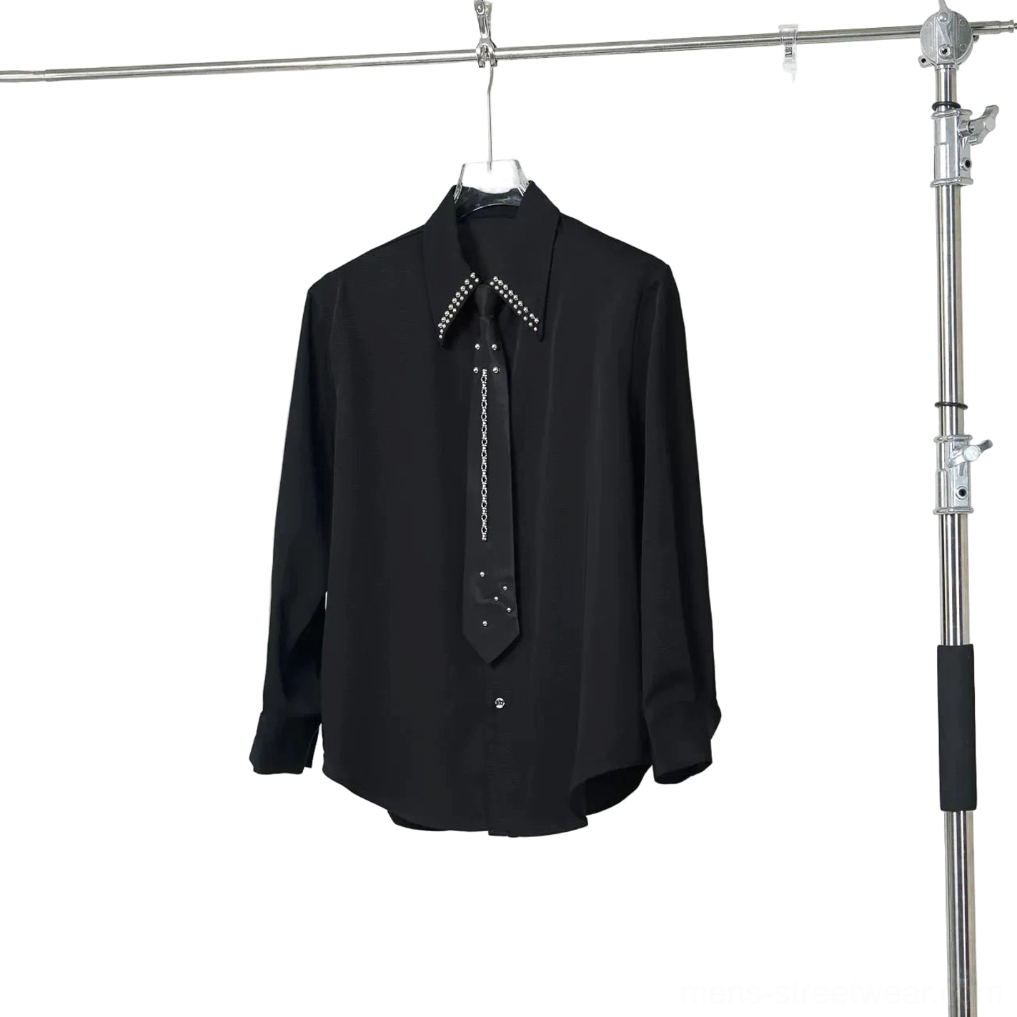 Black oversized long-sleeve shirt with crystal studded collar and matching chain tie hanging studio view