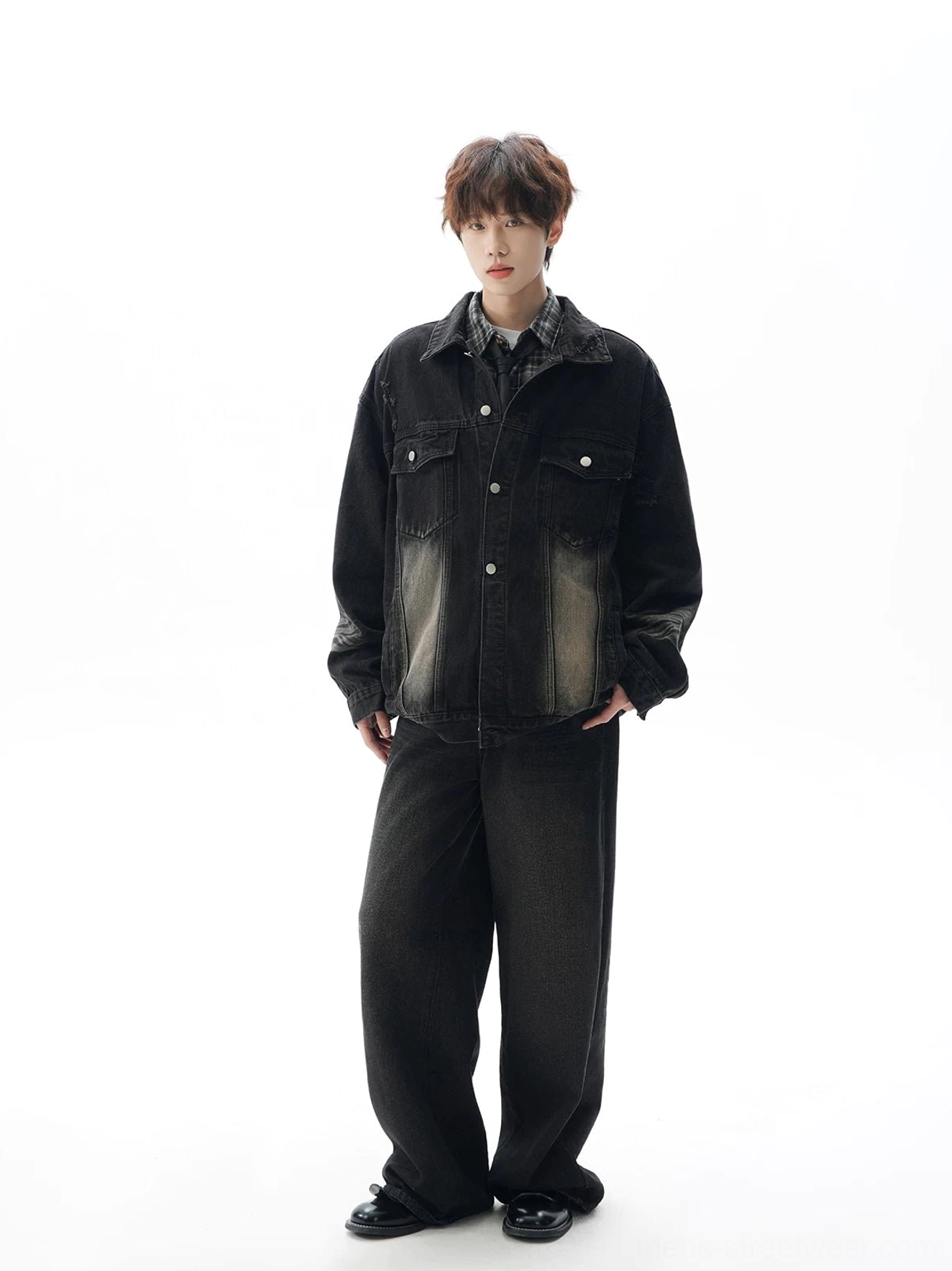Black oversized denim jacket styled with matching wide-leg denim pants, featuring a clean button front and monochrome streetwear look