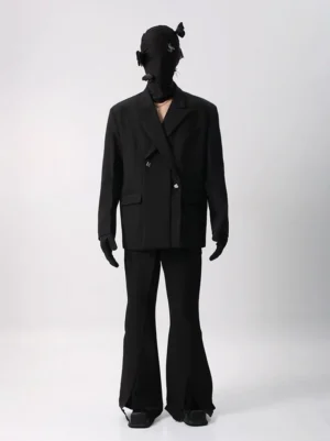 Black oversized double-breasted blazer and matching flared suit trousers shown in a full-body front view with notched lapel, flat pockets, and ankle slit details