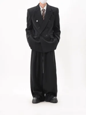 Black oversized double-breasted blazer and wide-leg pants set worn in a full-body front studio view