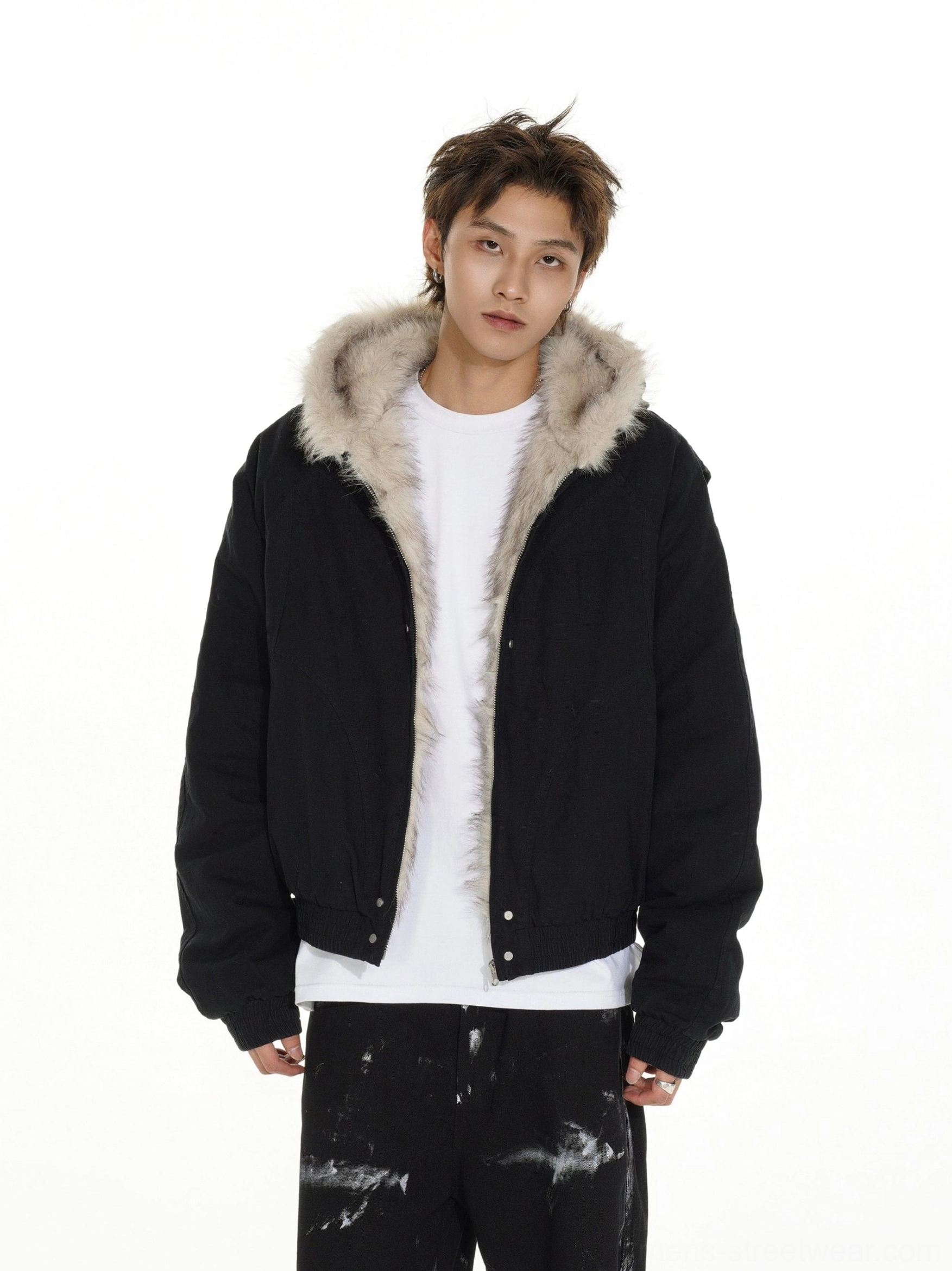 Black oversized faux fur lined cropped bomber jacket with visible snap buttons and plush hood lining