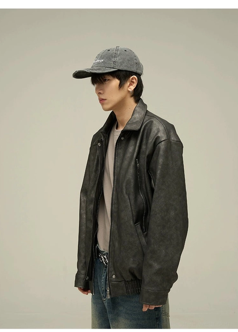 Left side profile of a black oversized faux leather jacket with drop shoulder construction, classic shirt collar, clean hem, and relaxed streetwear proportions