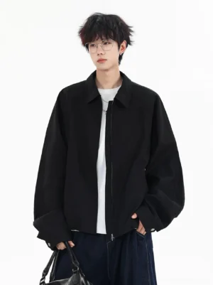 Black oversized full-zip boxy jacket shown from the front on a male model in a clean white studio