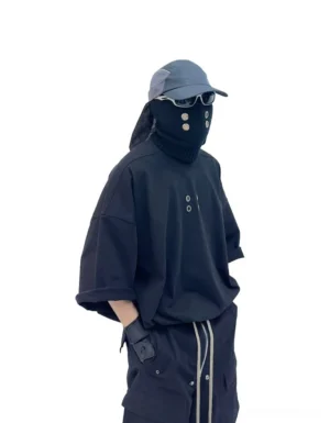 Black oversized streetwear T-shirt with boxy drop shoulder fit and subtle metal grommet chest detailing