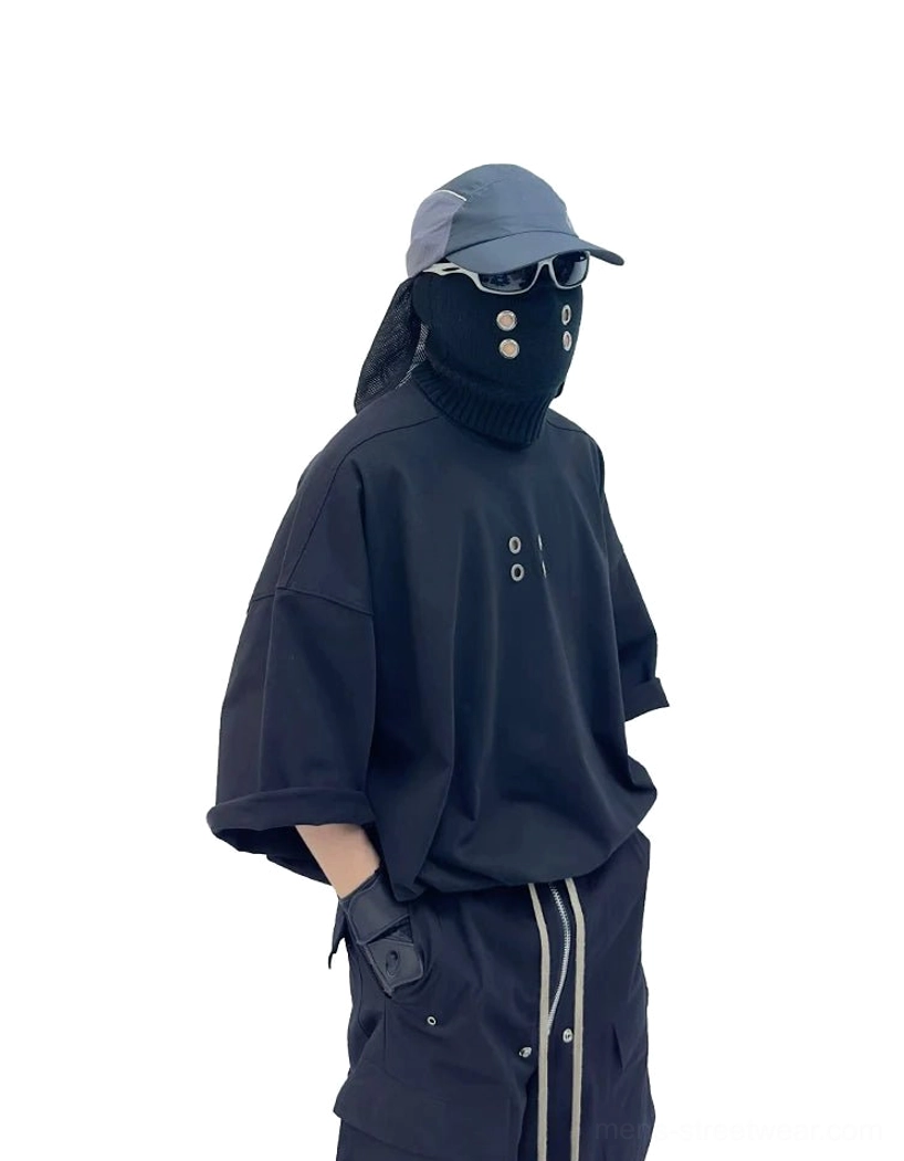 Black oversized streetwear T-shirt with boxy drop shoulder fit and subtle metal grommet chest detailing