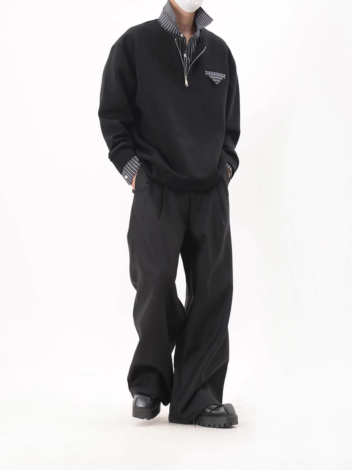 Side view of a black oversized half-zip layered collar sweatshirt with dropped shoulders and hidden striped shirt lining