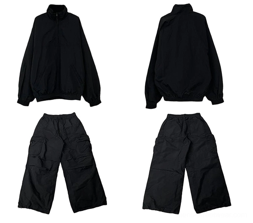 Black oversized half-zip windbreaker and utility cargo pants combination for casual urban fashion