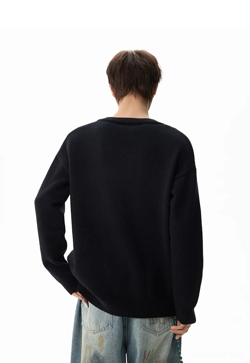 Back view of a black oversized henley knit sweater showing the clean seamless relaxed silhouette and soft knit fabric
