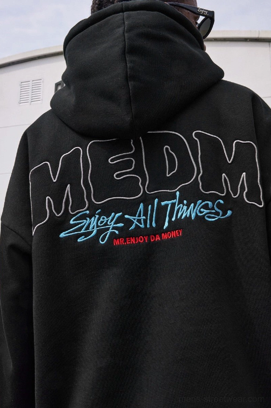 Back view of black oversized pullover hoodie with stitched outline graphic, decorative back lettering, and relaxed hooded silhouette