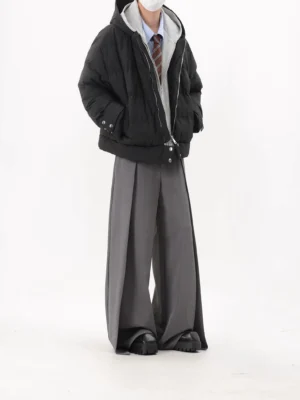 Black oversized layered puffer jacket side front view showing contrast grey zip hoodie insert and relaxed streetwear fit