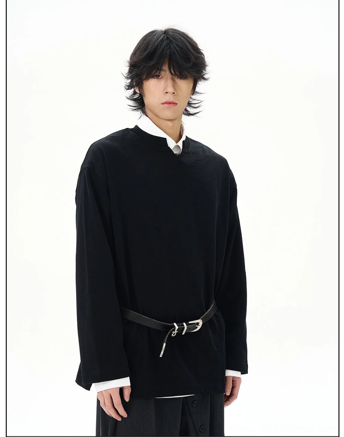Black oversized long-sleeve Korean streetwear shirt styled with a layered white collared shirt wide-leg trousers and leather belt
