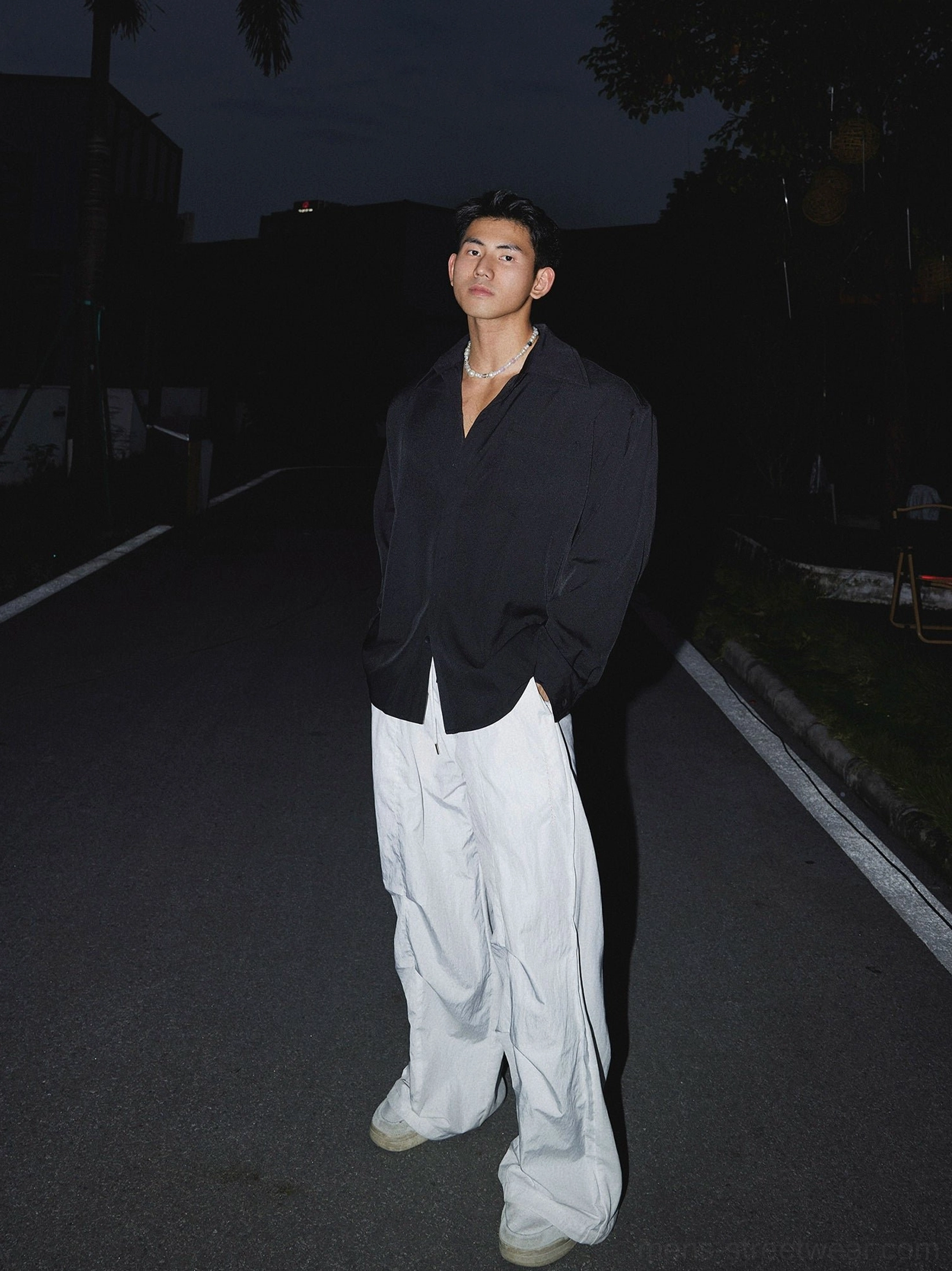Black oversized men's streetwear dress shirt styled with wide-leg white pants for a modern monochrome outfit