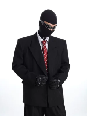 Black oversized pinstripe double-breasted blazer with padded shoulders, wide lapels, white shirt, red tie, sunglasses, and dark streetwear styling