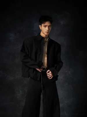 Black oversized poplin shirt worn open with relaxed long sleeves and black wide-leg pants for an avant-garde streetwear outfit