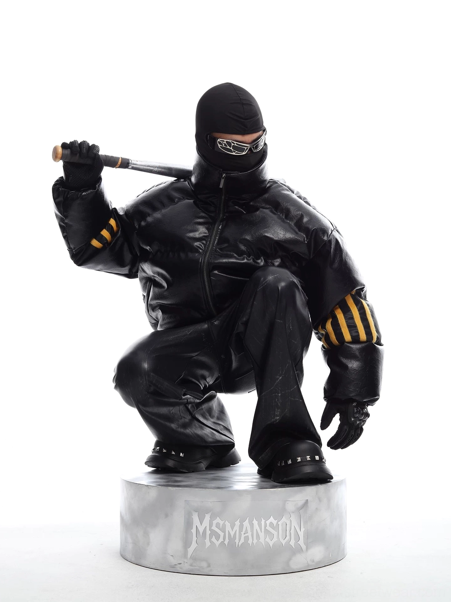 Black oversized quilted faux leather puffer jacket with yellow industrial sleeve stripe patches shown in a tactical Korean streetwear outfit