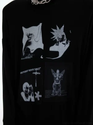 Close-up of black oversized punk graphic long sleeve tee showing cat creature dog and cross collage prints