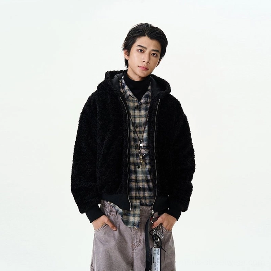 Black oversized sherpa fleece hooded bomber jacket with plaid layering and gray wide-leg pants