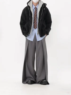Black oversized stand collar bomber jacket styled with gray wide leg trousers in a minimalist Seoul streetwear outfit