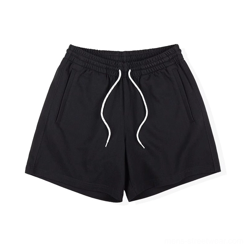 Alternative front view of solid black oversized sweat shorts showing clean side pockets and white drawstring detail