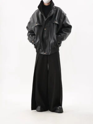Full-body front view of a black oversized utility bomber jacket styled with wide-leg trousers, chunky platform shoes, and a black turtleneck for Seoul streetwear fashion