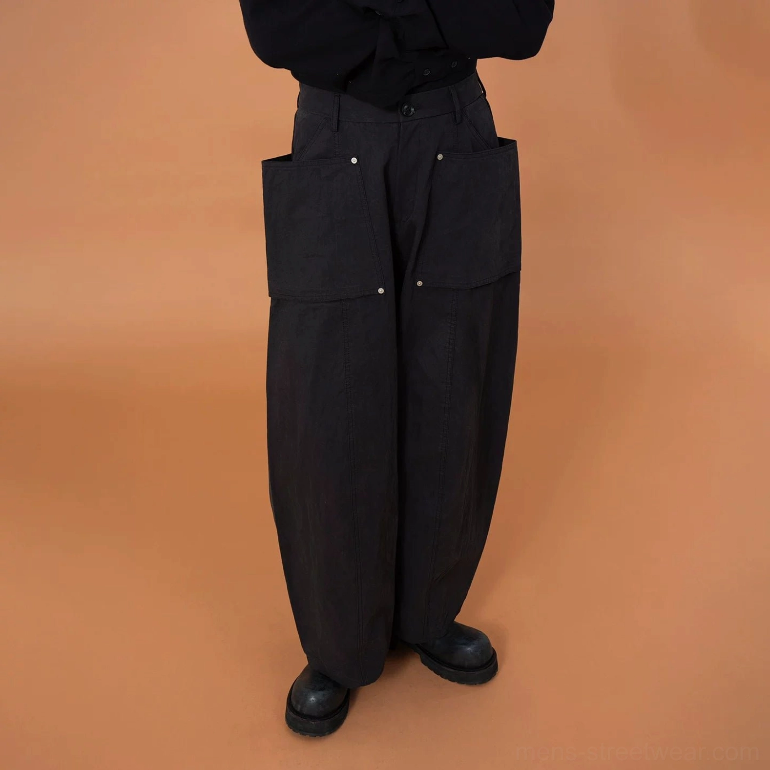 Black oversized utility cargo pod pants product image featuring an exaggerated wide-leg cut, structured cotton-blend fabric, and statement front pockets