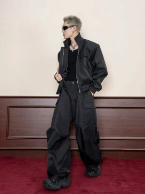 Black oversized utility jacket side view styled with wide-leg cargo pants and black work boots in Seoul streetwear look