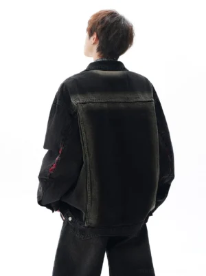 Black oversized vintage denim jacket shown from the back with gradient faded paneling, distressed sleeve detail, and relaxed streetwear fit