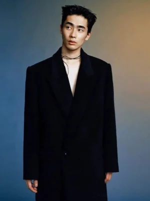 Black oversized wool long overcoat with wide tailored lapels shown in a full body front view for Korean streetwear styling