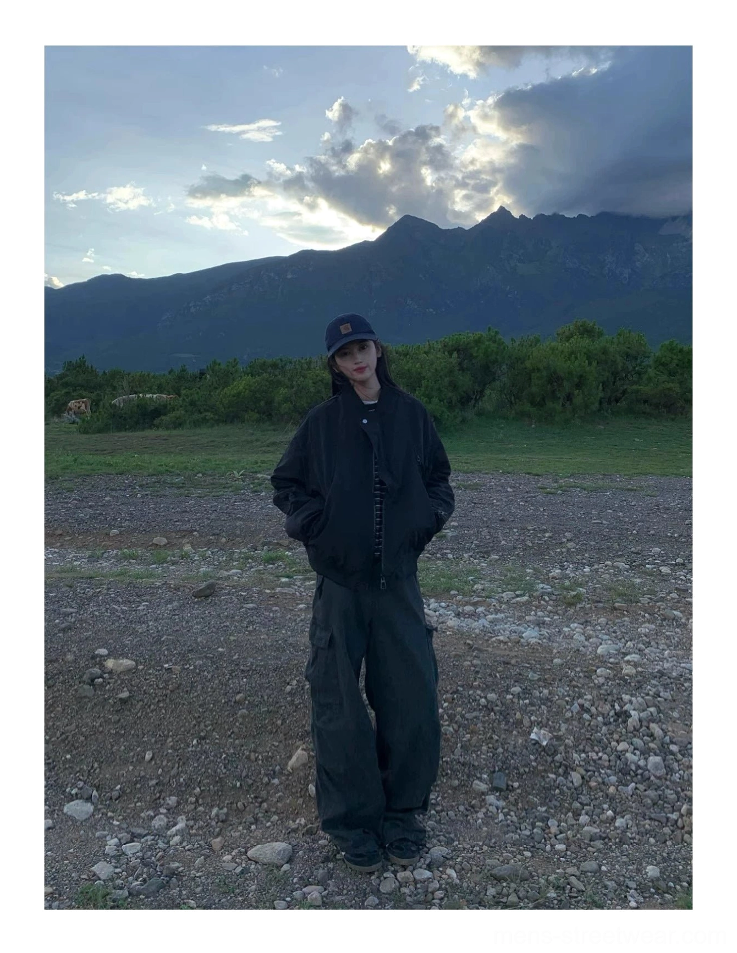 Black oversized zip-up flight bomber jacket rear side view showing relaxed silhouette and ribbed waistband