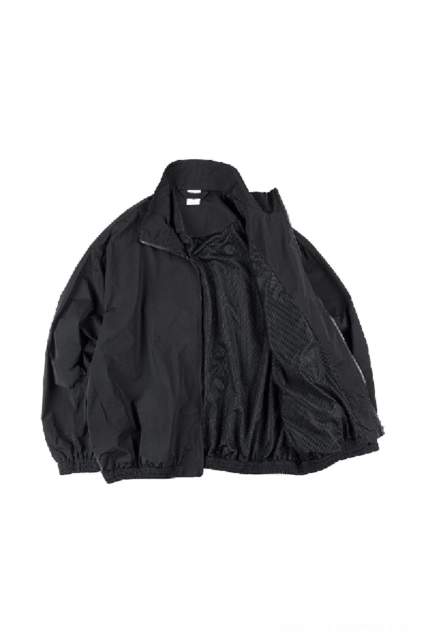 Black oversized zip-up windbreaker jacket open front view showing breathable mesh inner lining and dropped shoulders